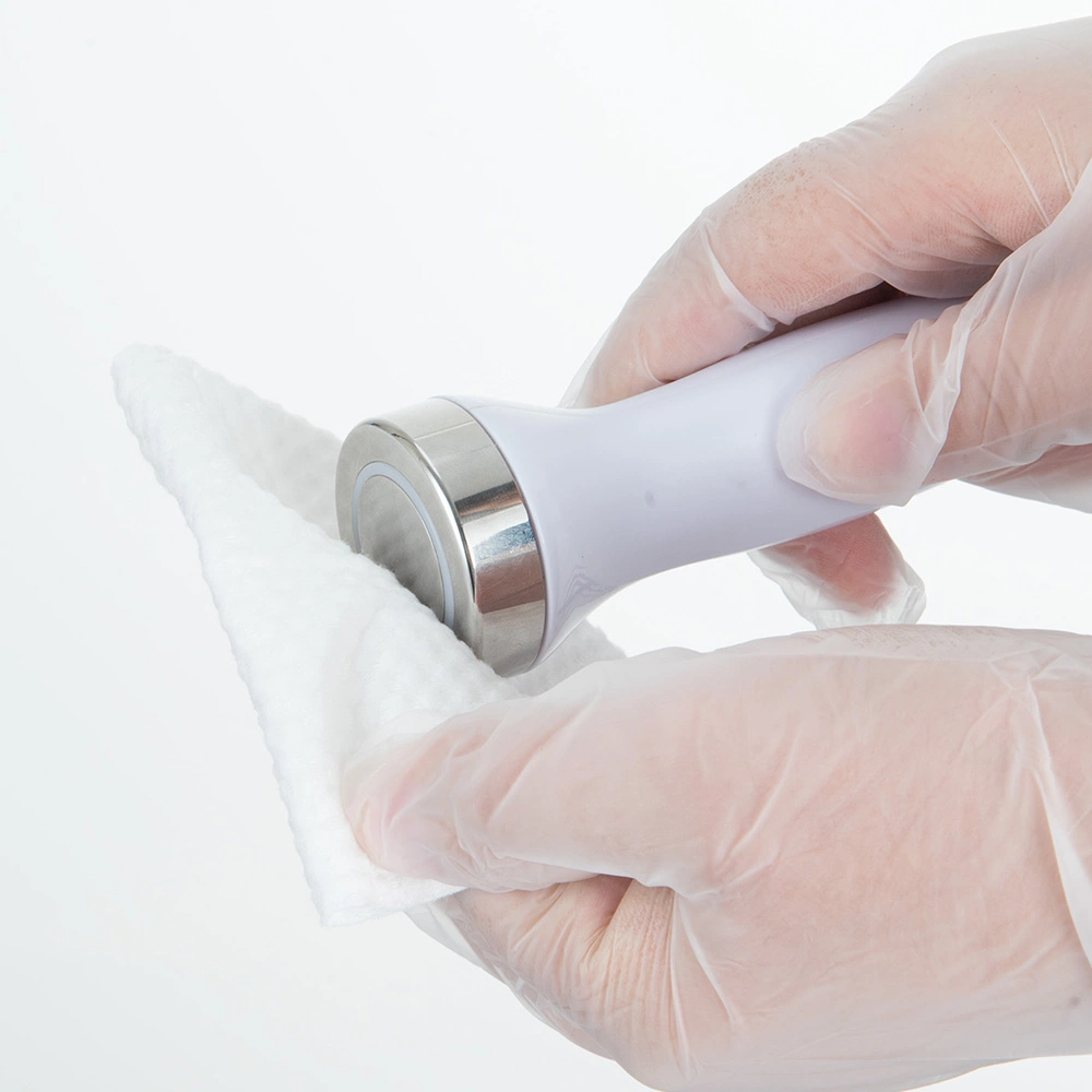 Gloved hands wiping an FC-68S1 facial-care handpiece